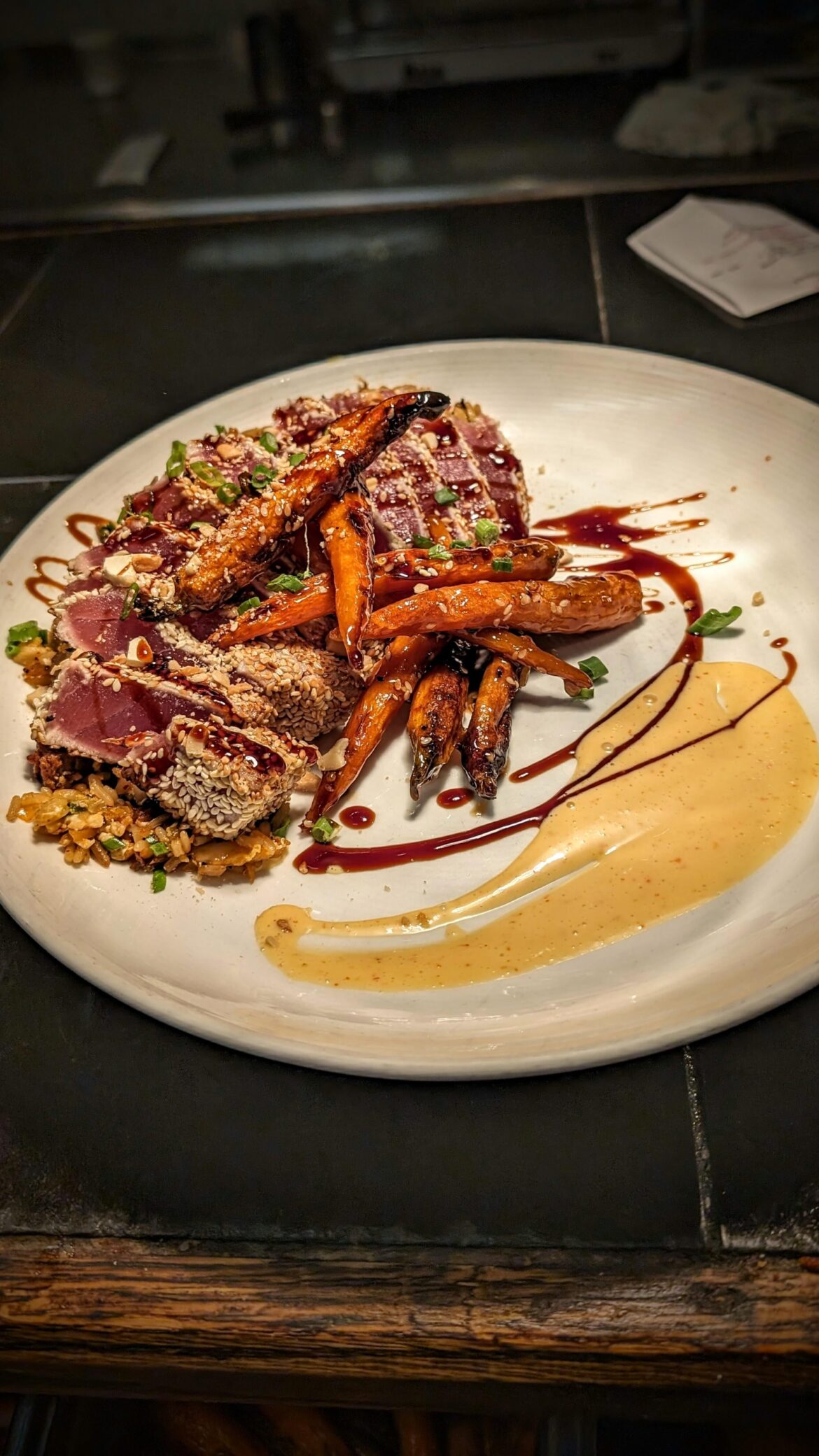 Pan Seared Sesame Ahi Tuna o/ Kimchi & Pork Belly Fried Rice, Garlic Soy Glazed Heirloom Carrot, Thai-Chili Kewpie, Roasted Cashew, Green Onion.