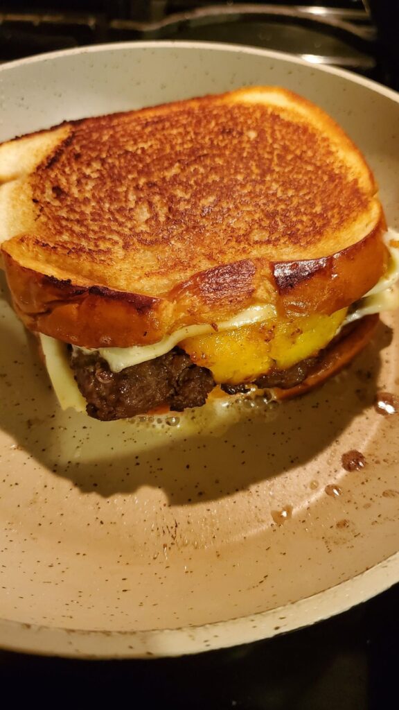 Bulgogi beef pineapple aged provolone patty melt on butter bread.