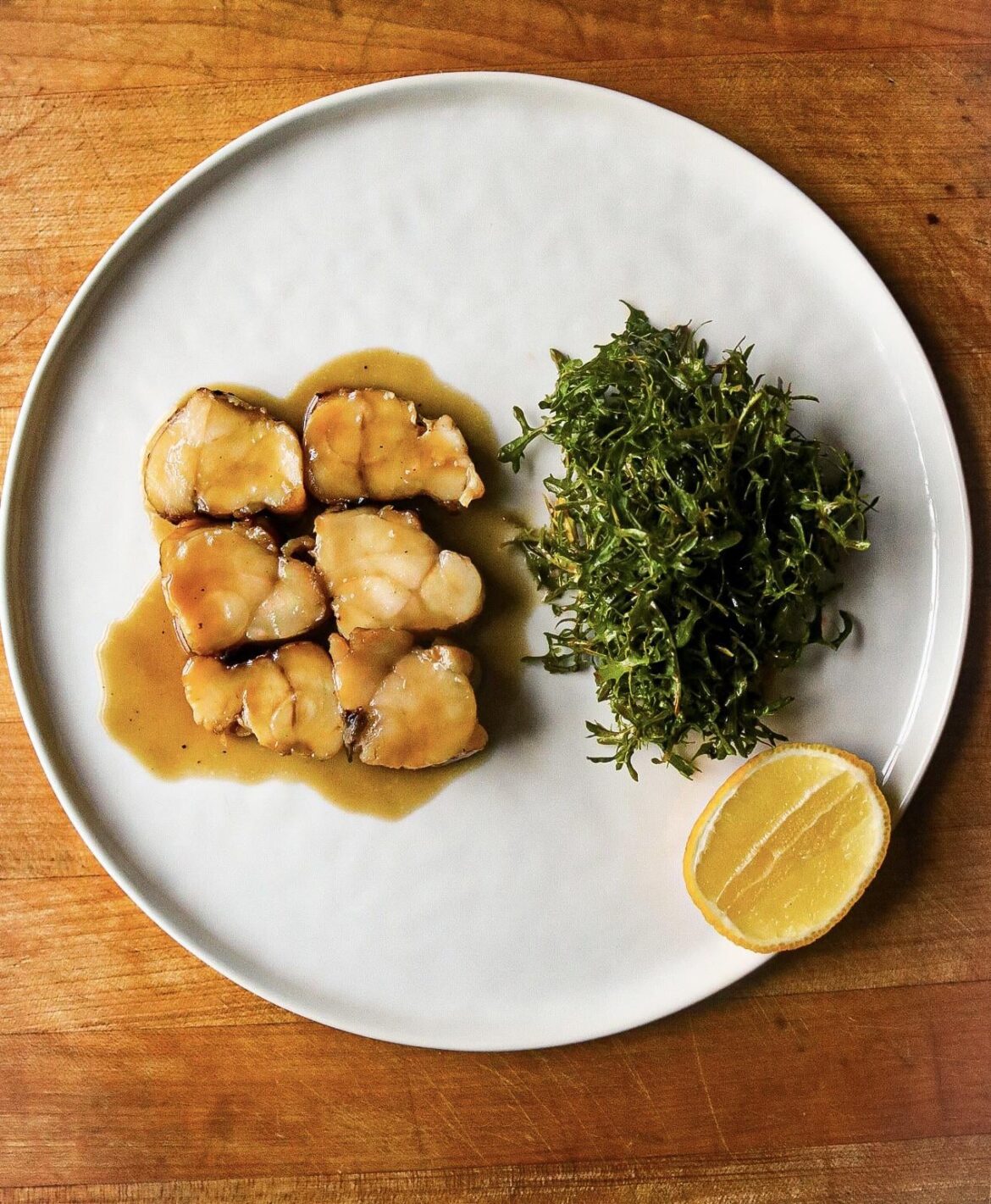 Grilled Monkfish, roasted fish jus, mustard green salad