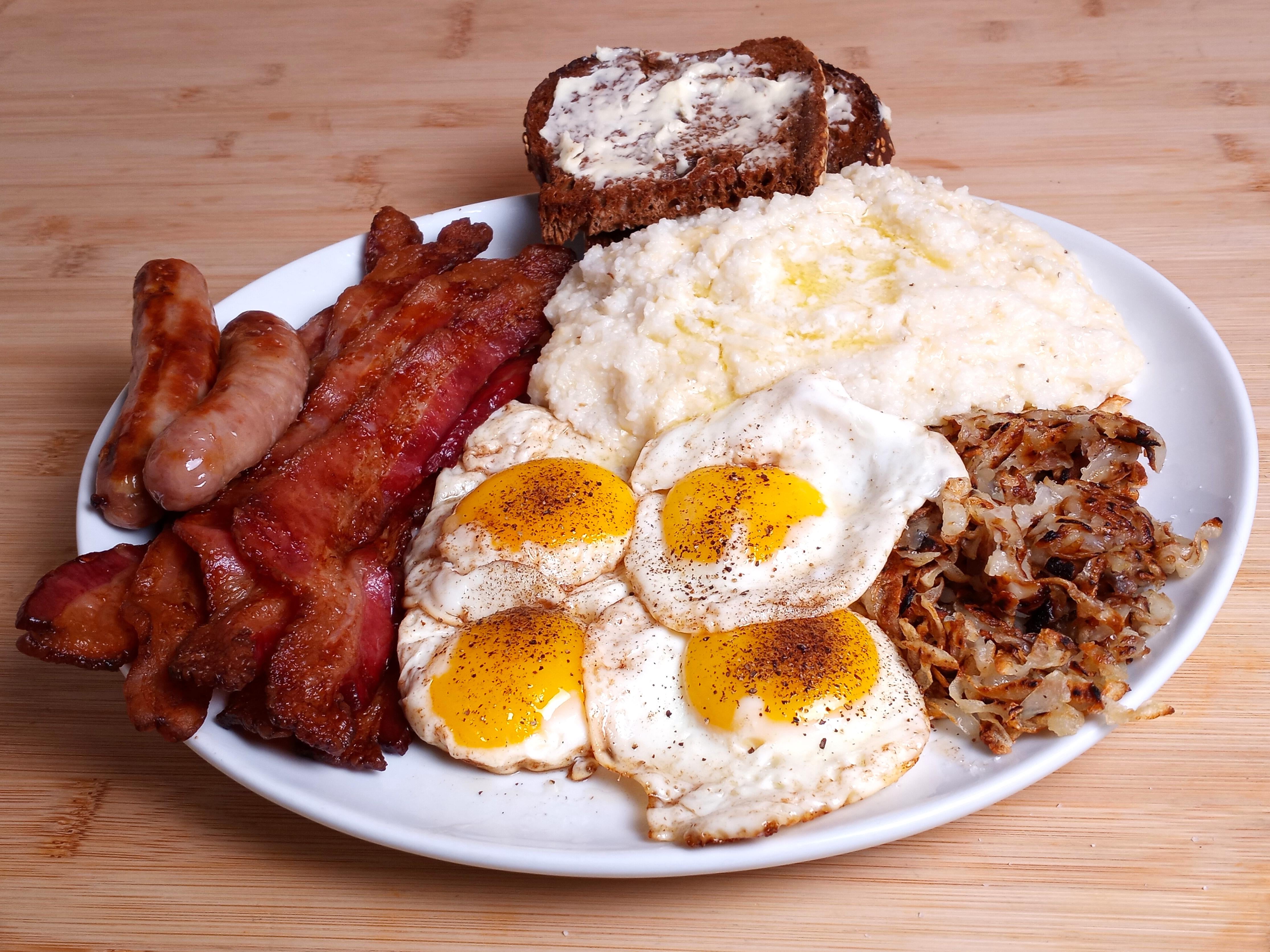 Bacon, Chipolatas and Eggs with Cheese Grits, Hash Browns and