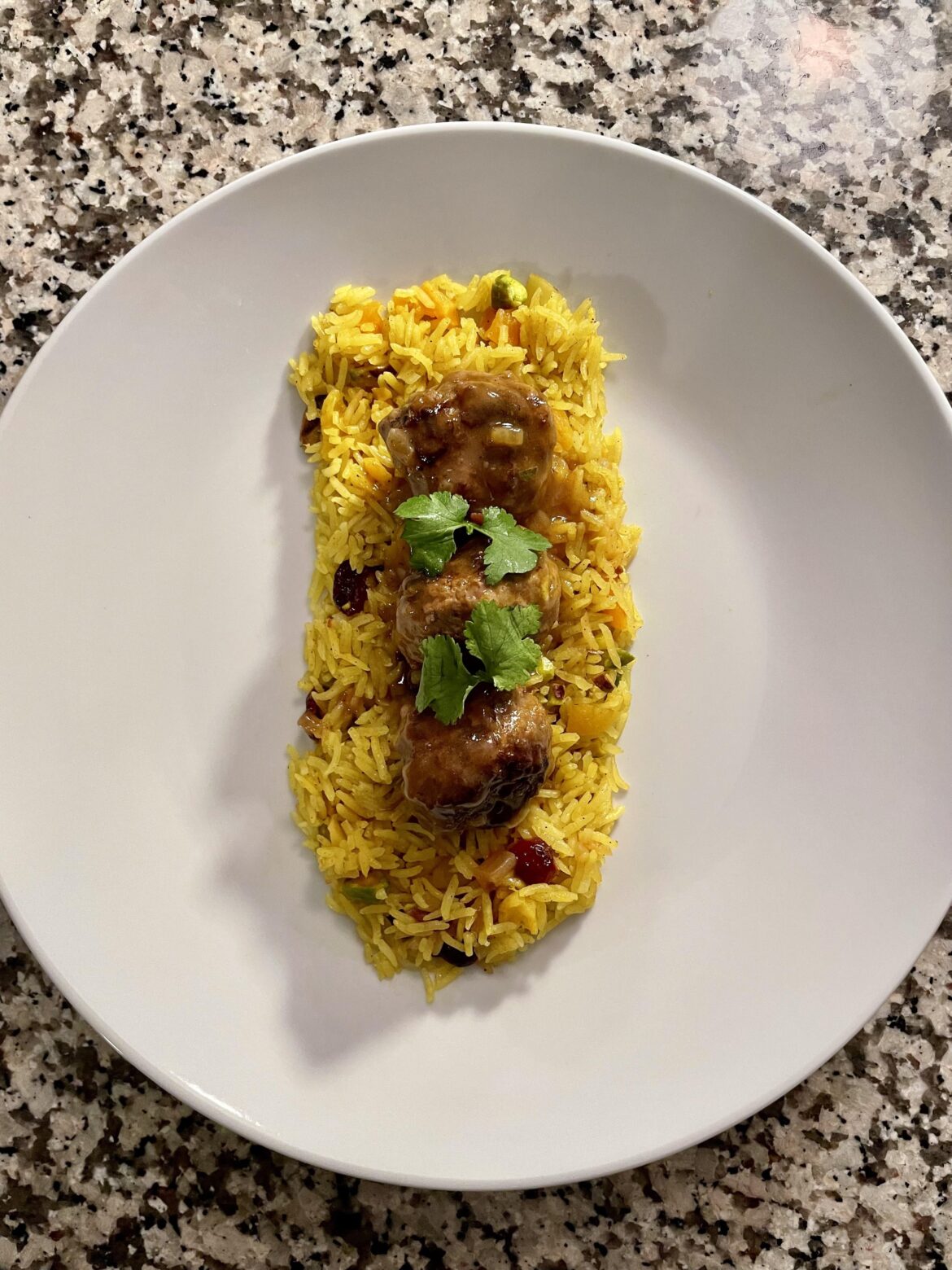 Persian lamb meatball, gravy, jeweled rice, parsley