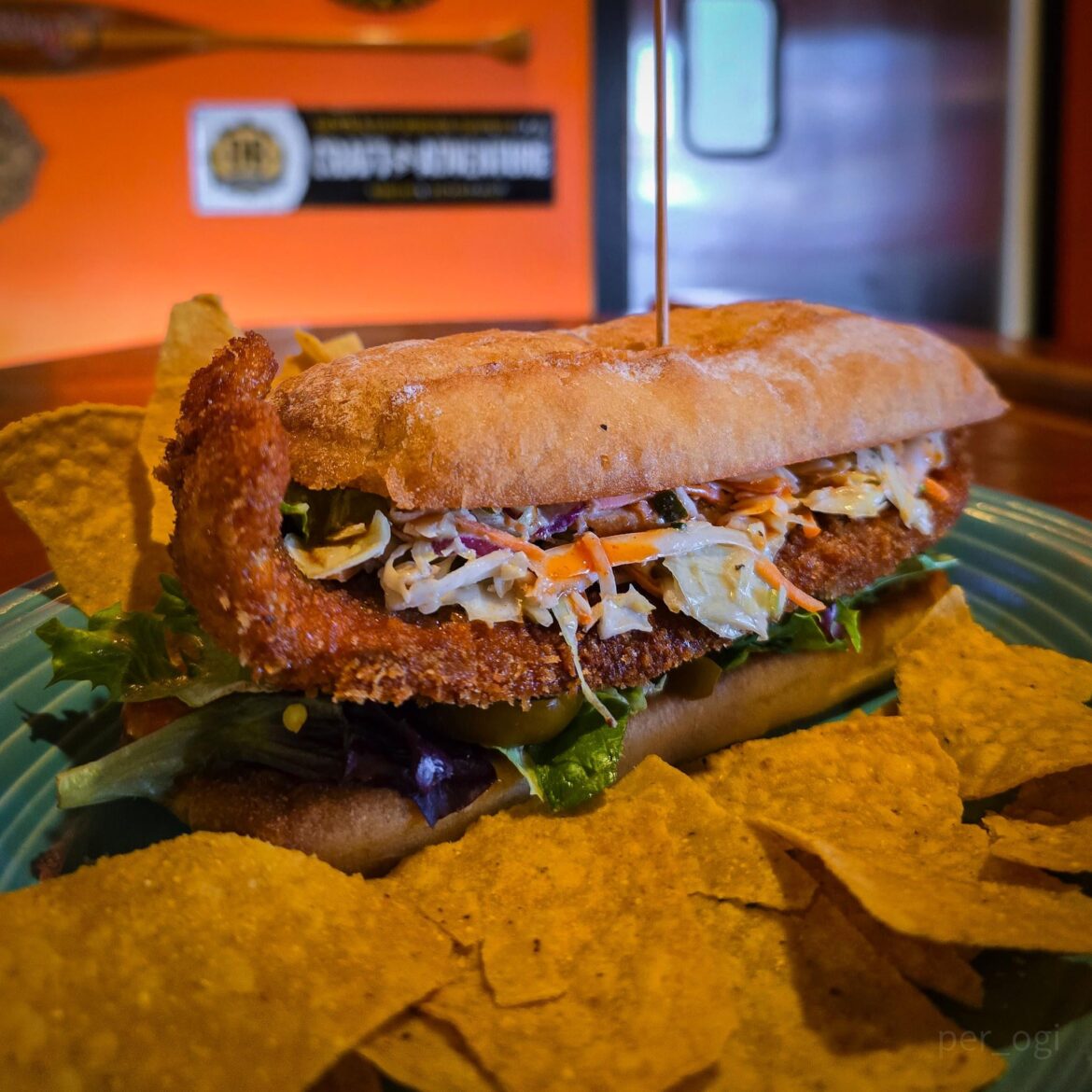 It's fish Fry season! - The "Lent Roller" - baguette w/ arcadian greens, pickled cherry peppers, a hand-breaded marinated catfish filet, bread and butter pickle cumin slaw, smoked maple hot sauce