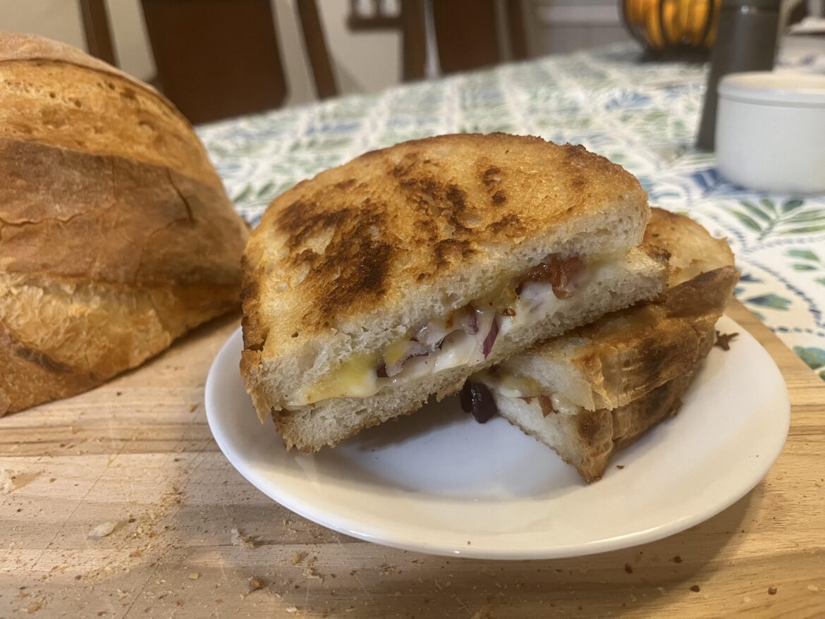 Grilled provolone and cheddar jack with red onion and bacon on homemade bread.