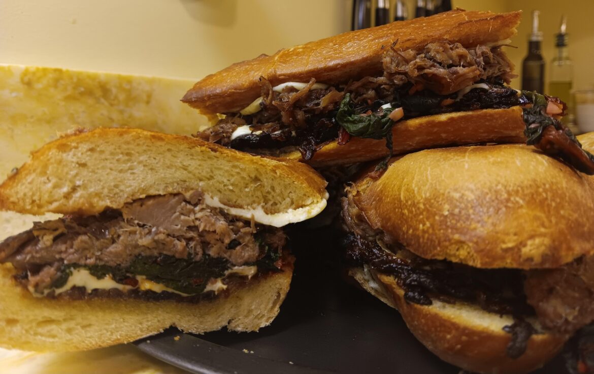 Braised chuck with bacon jam, mozzarella and Utica greens on french bread