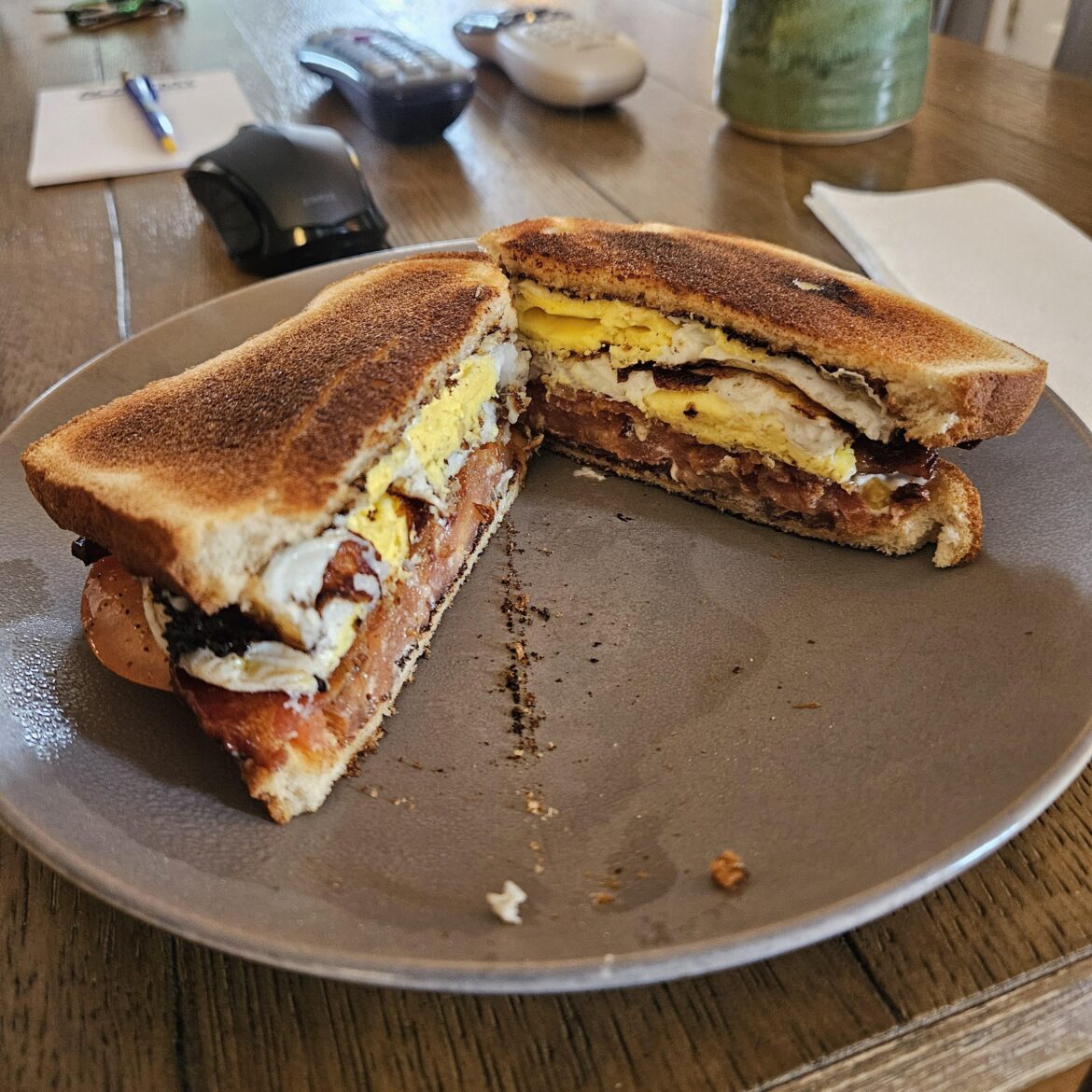 Bacon, tomato, and fried egg on Hawaiian loaf.