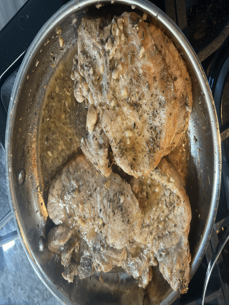 Keto Garlic Herb Pork Chops served over Keto Cauliflower Mash