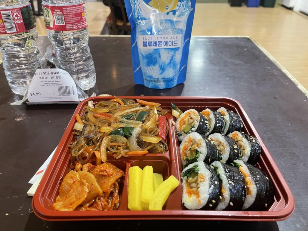 Korean brunch…sort of a Kimbap (fish cake) and Jap chae bento box, some blue lemonade and water, with a bokkuem kimchi samgak Kimbap…Woori Family Mart, Sf CA
