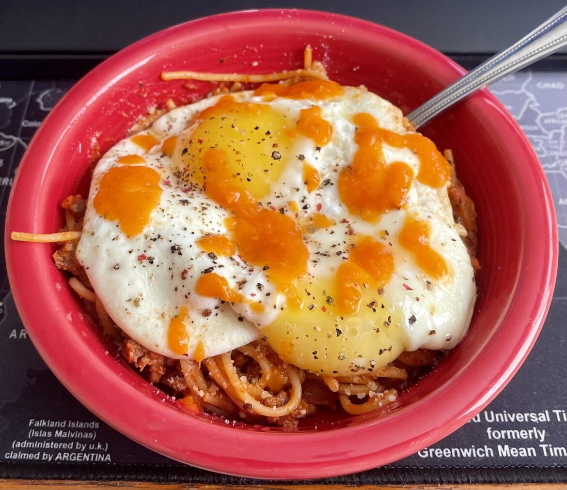 Fried eggs over venison spaghetti with Parmesan and home made lacto-fermented habanero sauce.