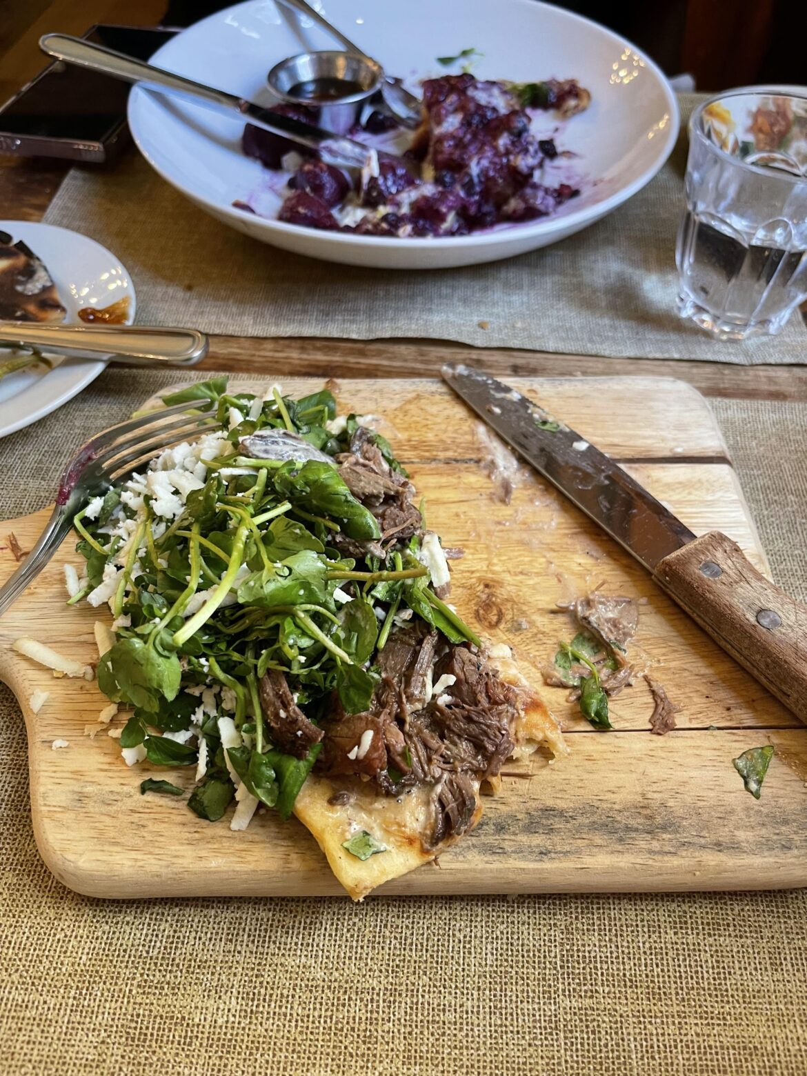 Shortrib flatbread on a cracked cutting board