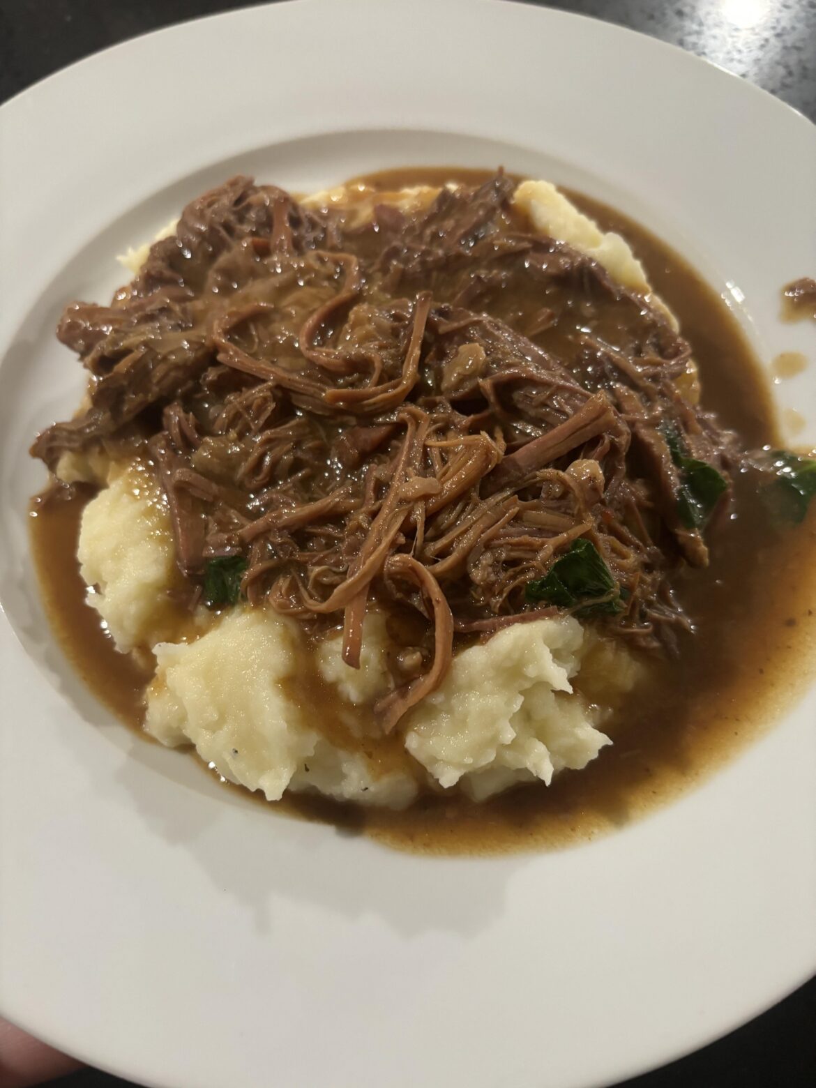 Slow cooker pot roast over mashed potatoes.