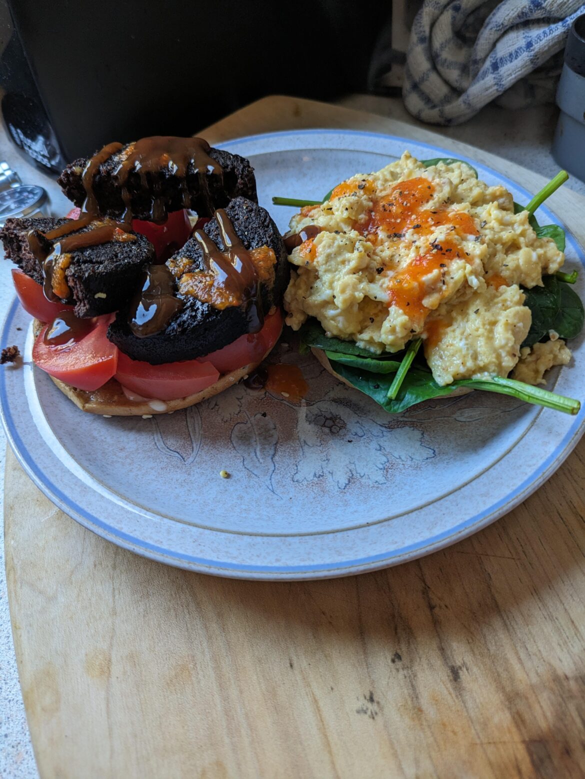 Bagels with black pudding, tomato, scrambled egg, baby spinach.