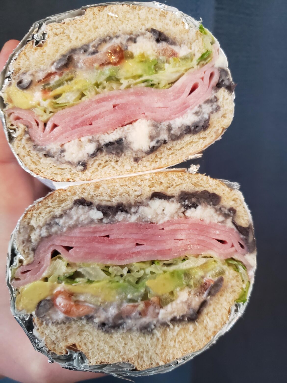 Ham, Avocado, tomato, lettuce, pickled jalapeños, refried beans and queso fresco. On a bolillo.