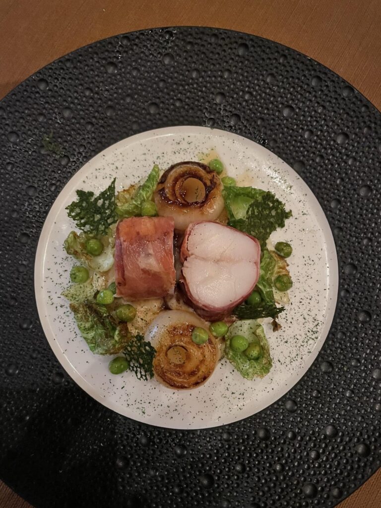 Speck wrapped monkfish - cipollini onions, fried Brussel leaves, parsley/tarragon tuile, English peas, parsnip purée, brown butter.