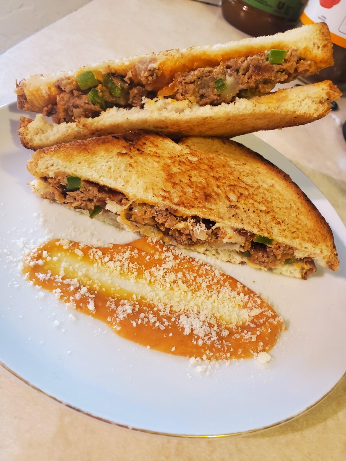 (I made) Meatloaf patties with fried queso oaxaca and aji amarillo/tomato sauce