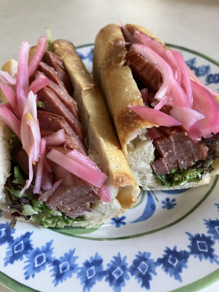 Summer sausage, greens, picked onions, horseradish cream cheese, baguette