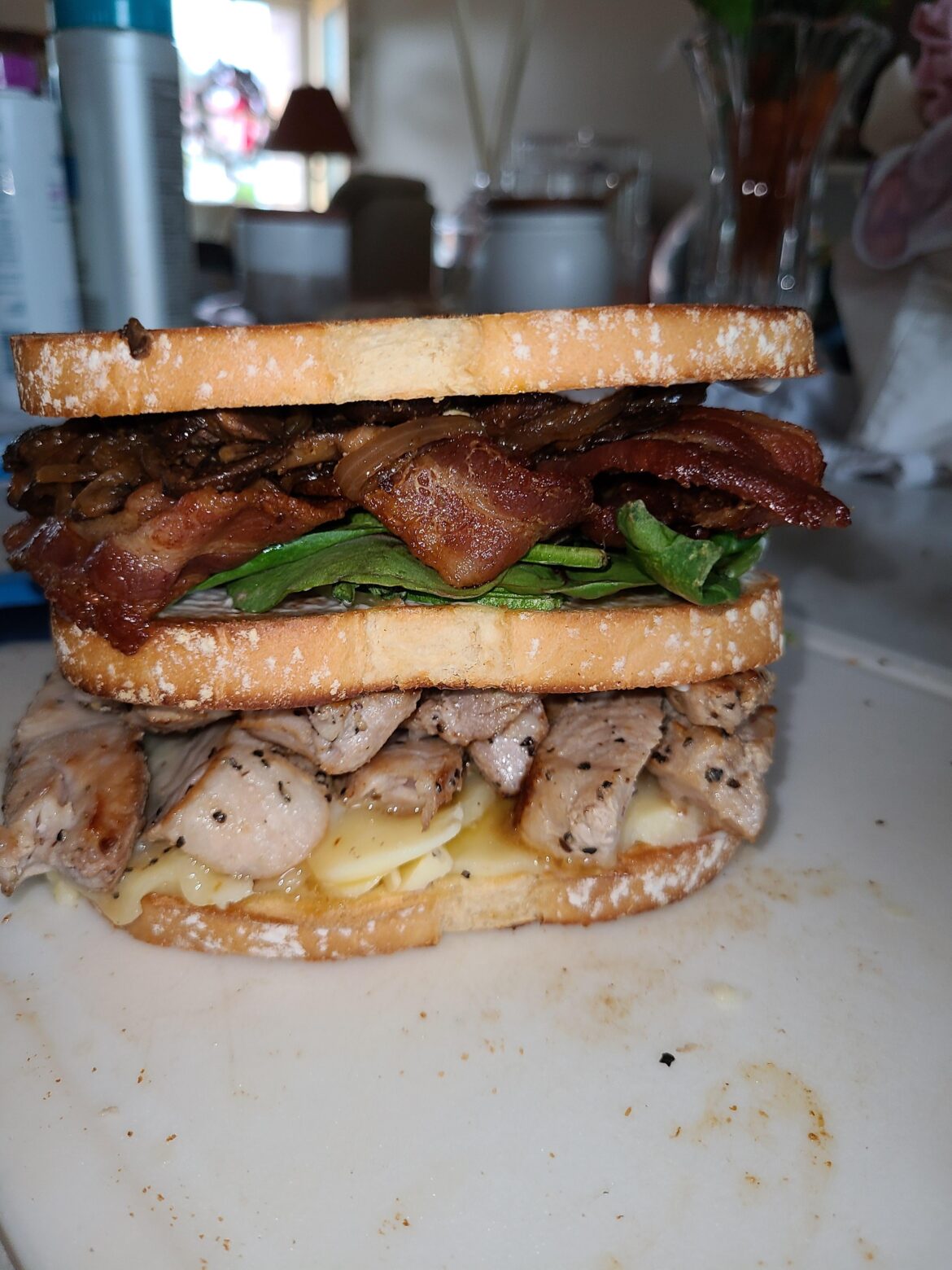 The Leftover Club. Smoked Gouda, Pork Chop, Sautéed Mush and Onion, Bacon, Mixed Greens. In need of frill picks.