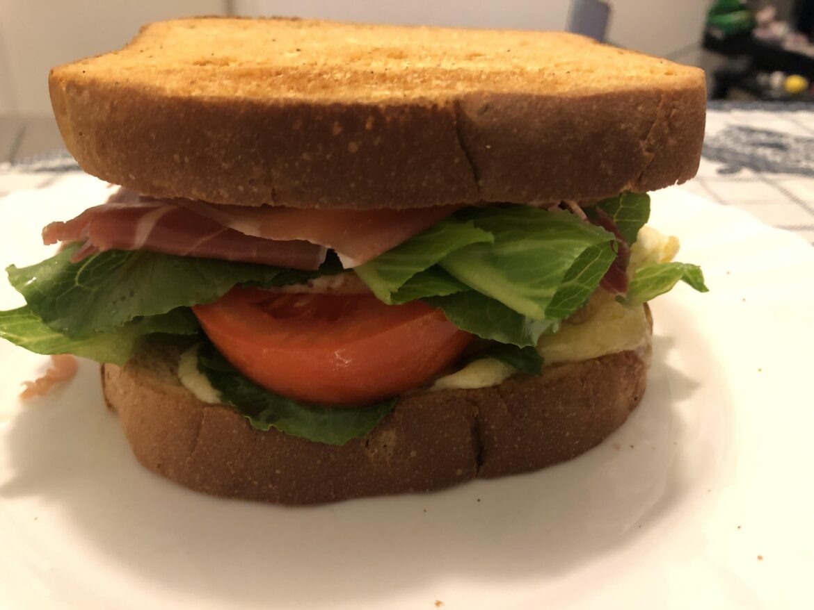 [OC] Cheese, egg, lettuce, tomato, Parma ham sandwich after workout.