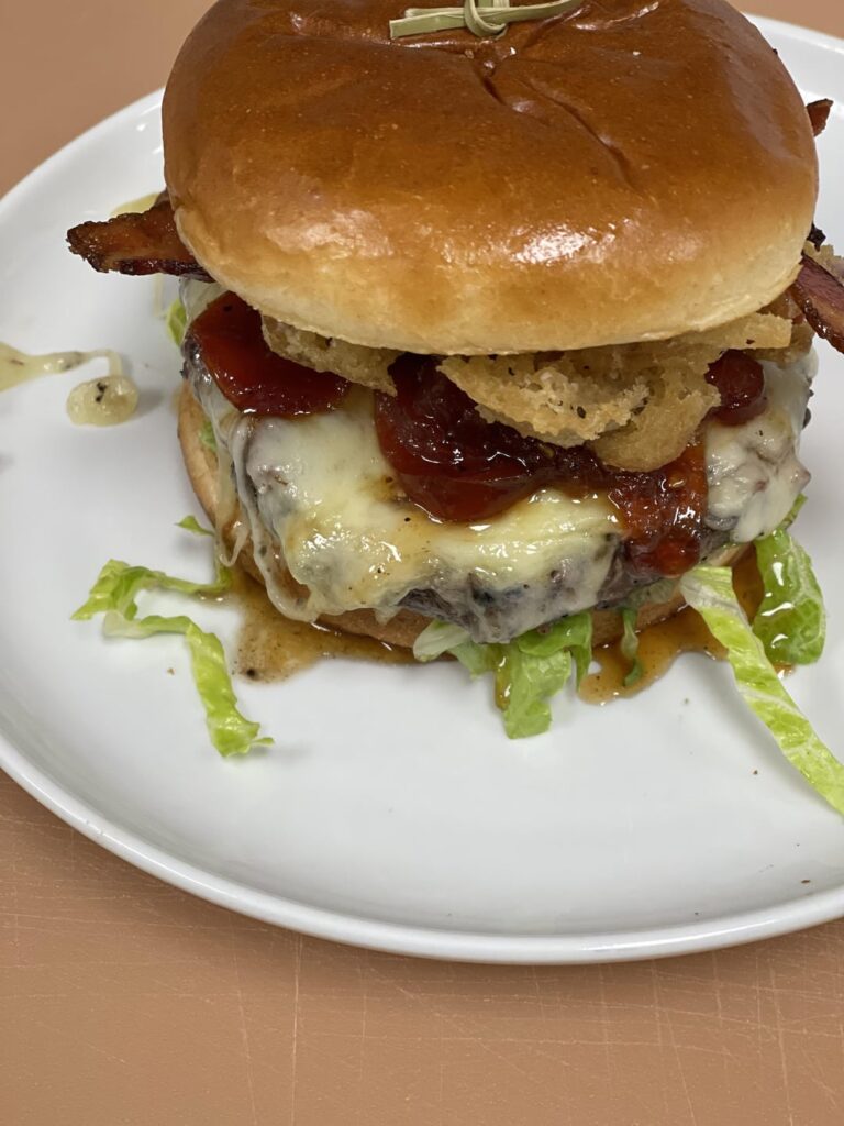 Sandwich #1 Burger w/ Swiss cheese, bacon, fried onions, lettuce and spicy mayo. Sandwich #2 Spicy bbq chicken breast, fried green tomato, and citrus slaw.