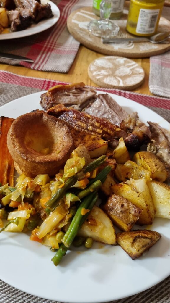 [Homemade] roast shoulder pork , with roasted potatoes, honey roasted carrot , porkies and left over runner beans , Leek and cauliflower leaf ... "thing"