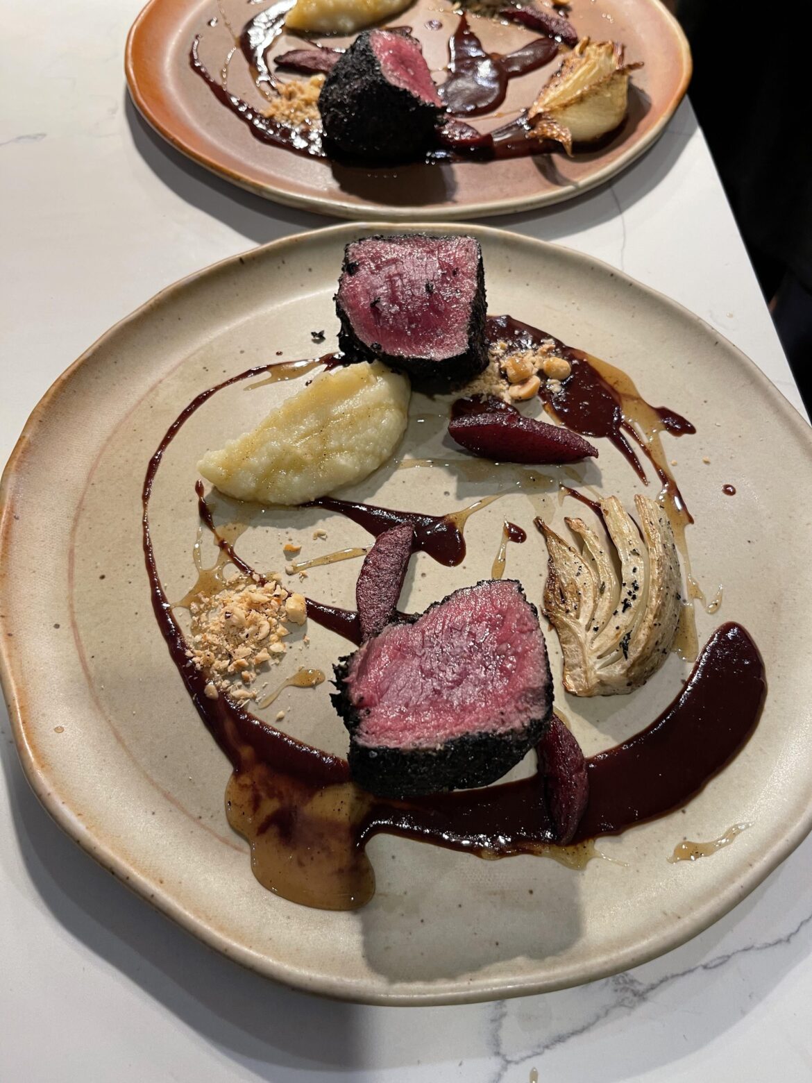 Venison, celery root puree, black current, hazelnut, fennel, wine poached pear