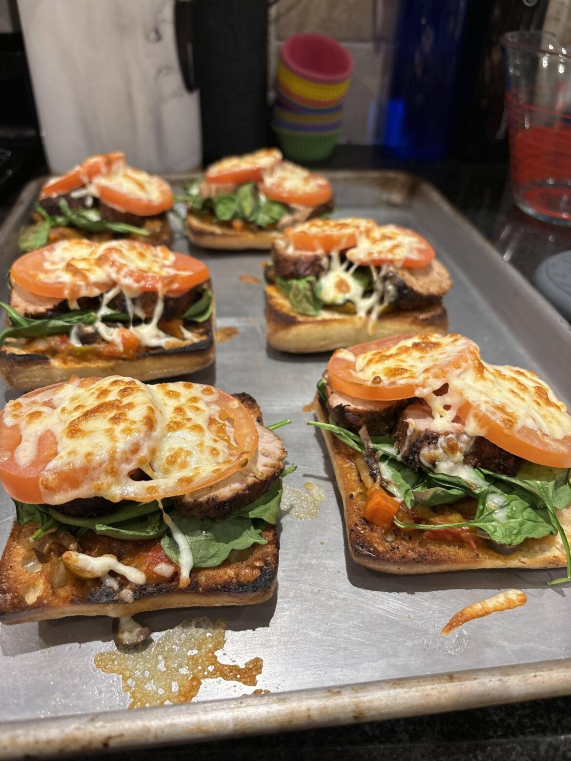 Improv. Marinated bbq pork tenderloin on grilled ciabatta with antipasto, spinach, tomato and mozz.