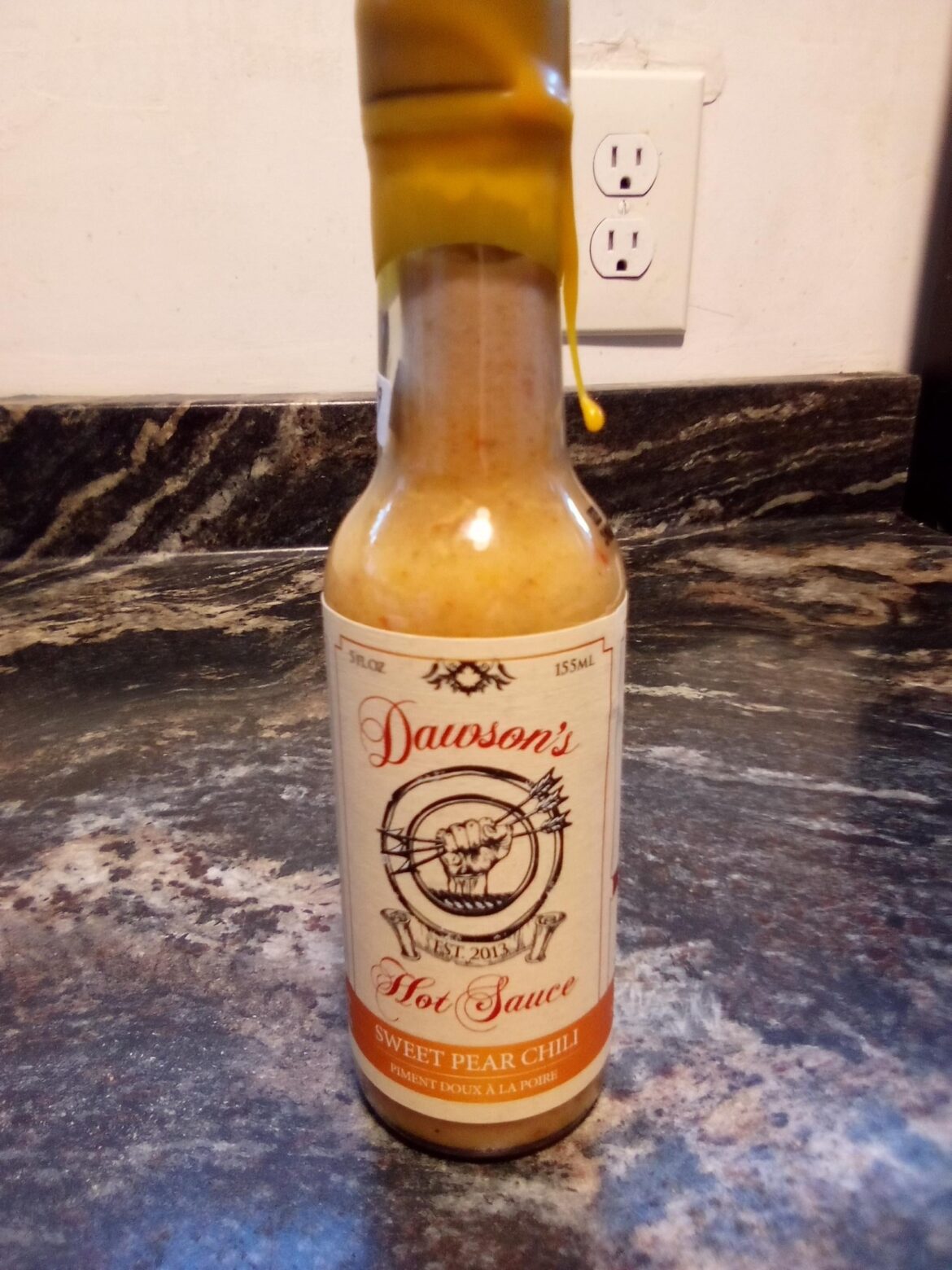 Dawson's Hot Sauce, sweet pear chili flavor. Found at a funky local secondhand shop that has a whole big shelf of hot sauces. More in comments.