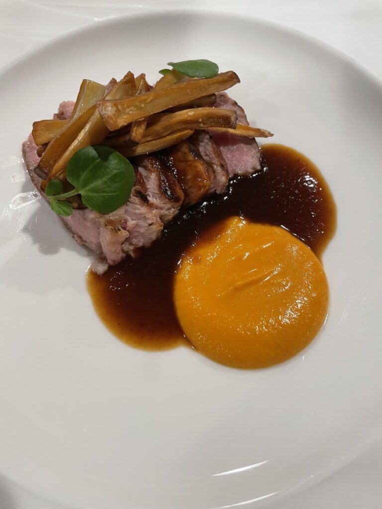 Sake brined Berkshire Pork Chop roasted over wood fire, Koginut Squash Puree, Roasted King Trumpet Mushrooms, Sake jus