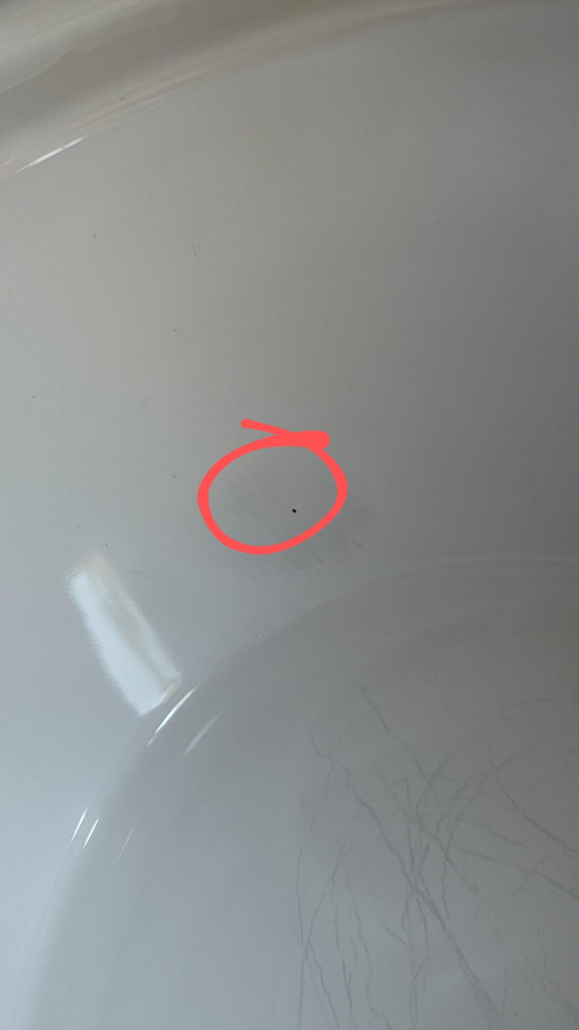 Small black dot on slow cooker pot that won't scrub off...