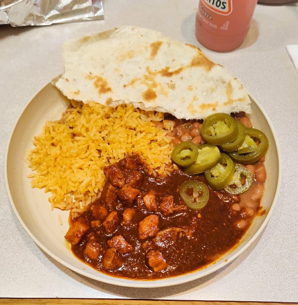 Asado de Puerco with rice and beans on the side