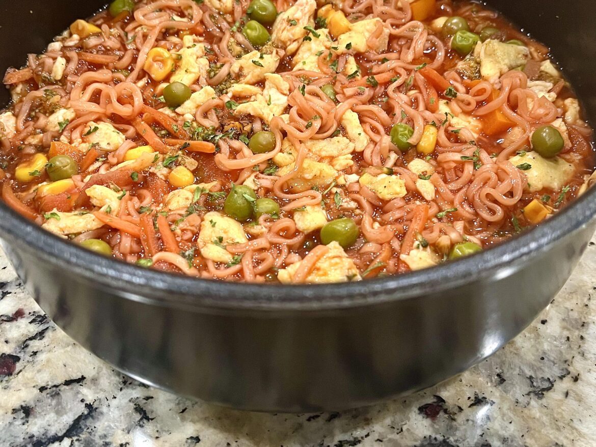 Ramen noodles with veggies and scrambled eggs in spicy and garlicky beet broth.