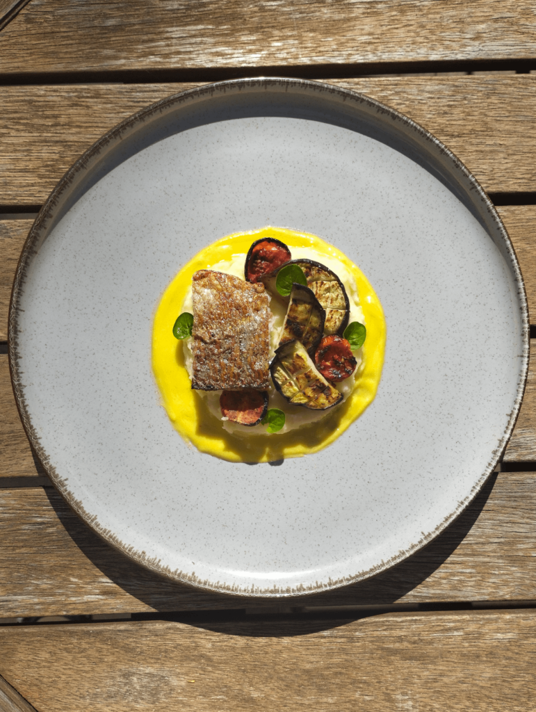 Crispy skin silver bream, celeriac-garlic-potato mash, pan fried eggplant, semi-dried cherry tomatoes and a saffron- champagne beurre blanc sauce.