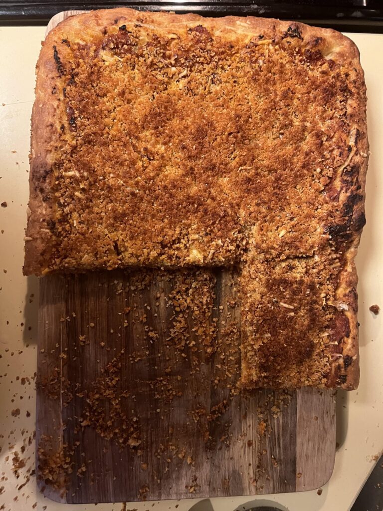 Sfincione! Tastes…deluxe. Pretty complex flavor and has all of the textures…soft, crunchy, chewy…great stuff