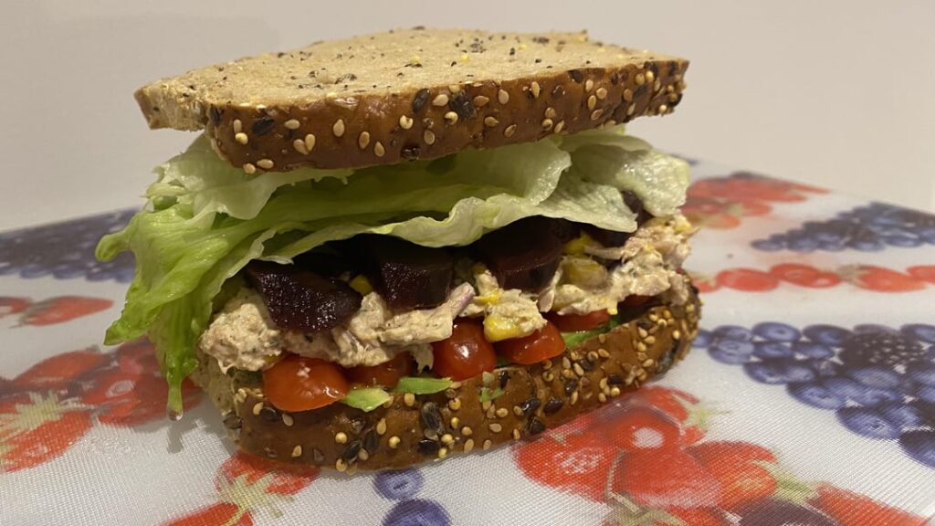 Tuna sandwiches on seeded toast with salt and pepper crisps (tuna, mayo, red onion, avocado, tomatoes, lettuce, corn, beetroot, seasonings)