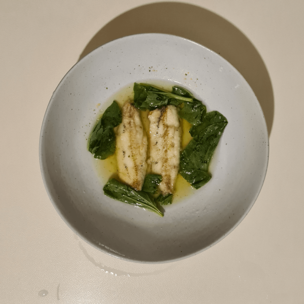 Fried fish in broth with greens