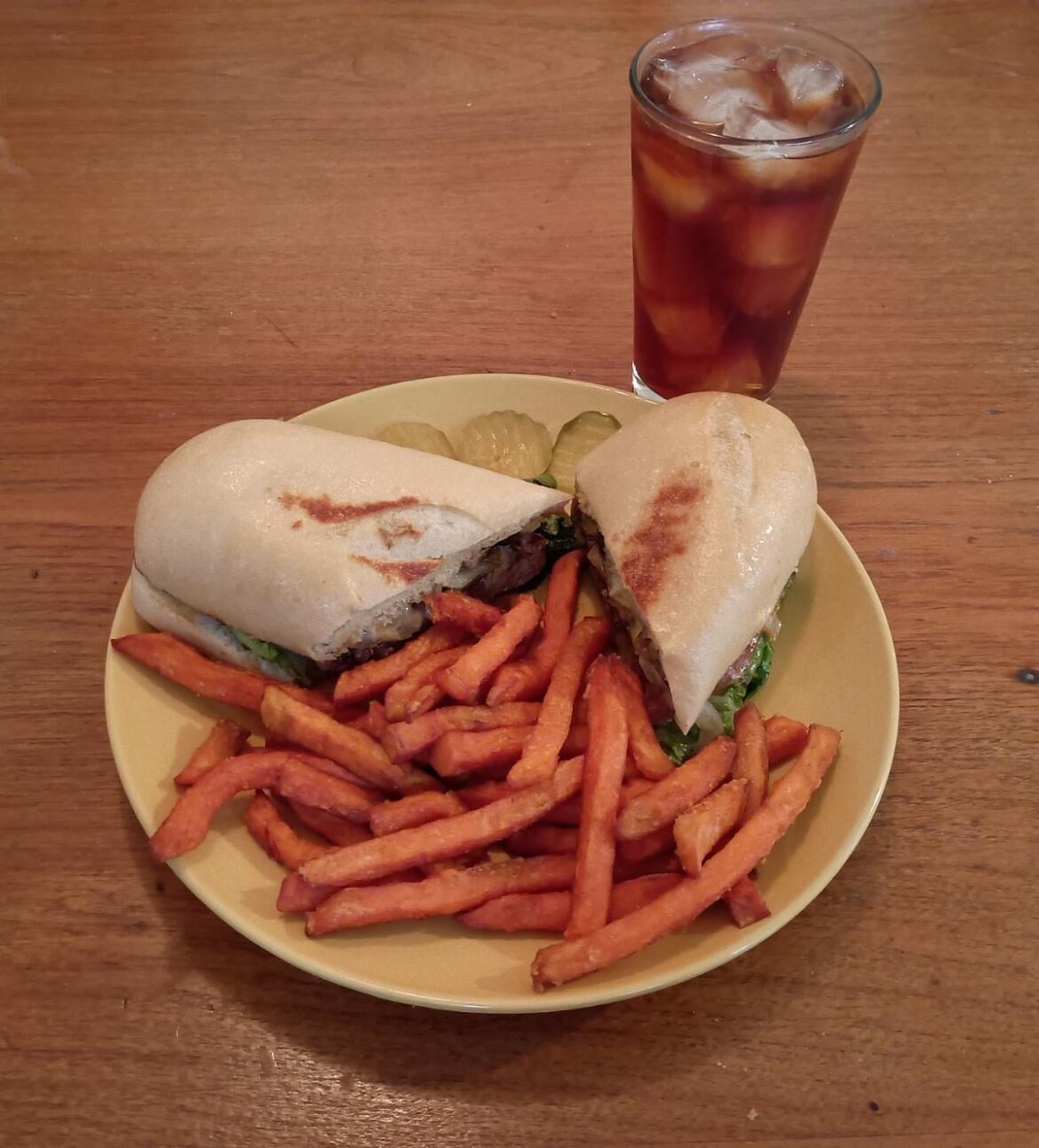 TJ's Roadhouse, steak sandwich with a side of sweet potato fries.