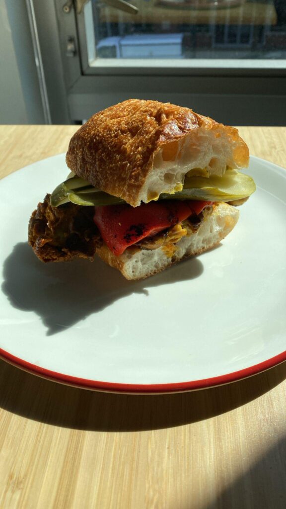 Chicken tikka, roasted red pepper, pickle, roasted garlic achaar, francese