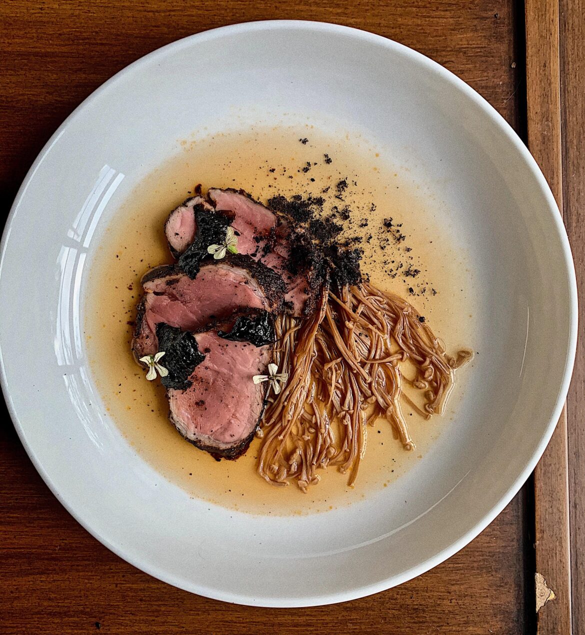 Coffee rubbed Pork, Mushroom Broth, Enoki Mushroom, Arugula Flower