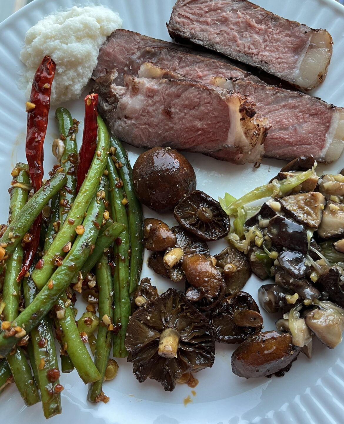 Stir fried green beans, sesame oil shiitakes, buttery chestnut mushrooms and New York strip with homemade horseradish