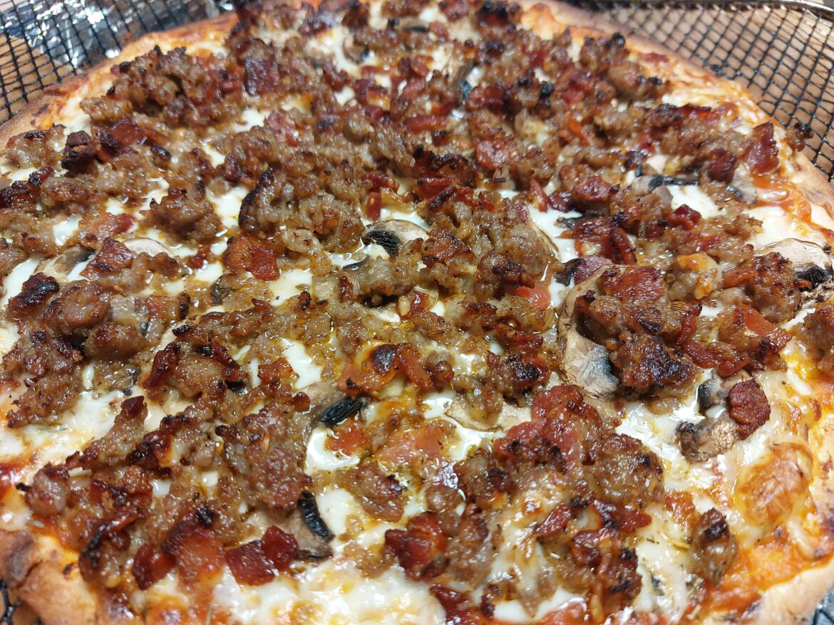 Sausage, bacon, and mushroom pizza