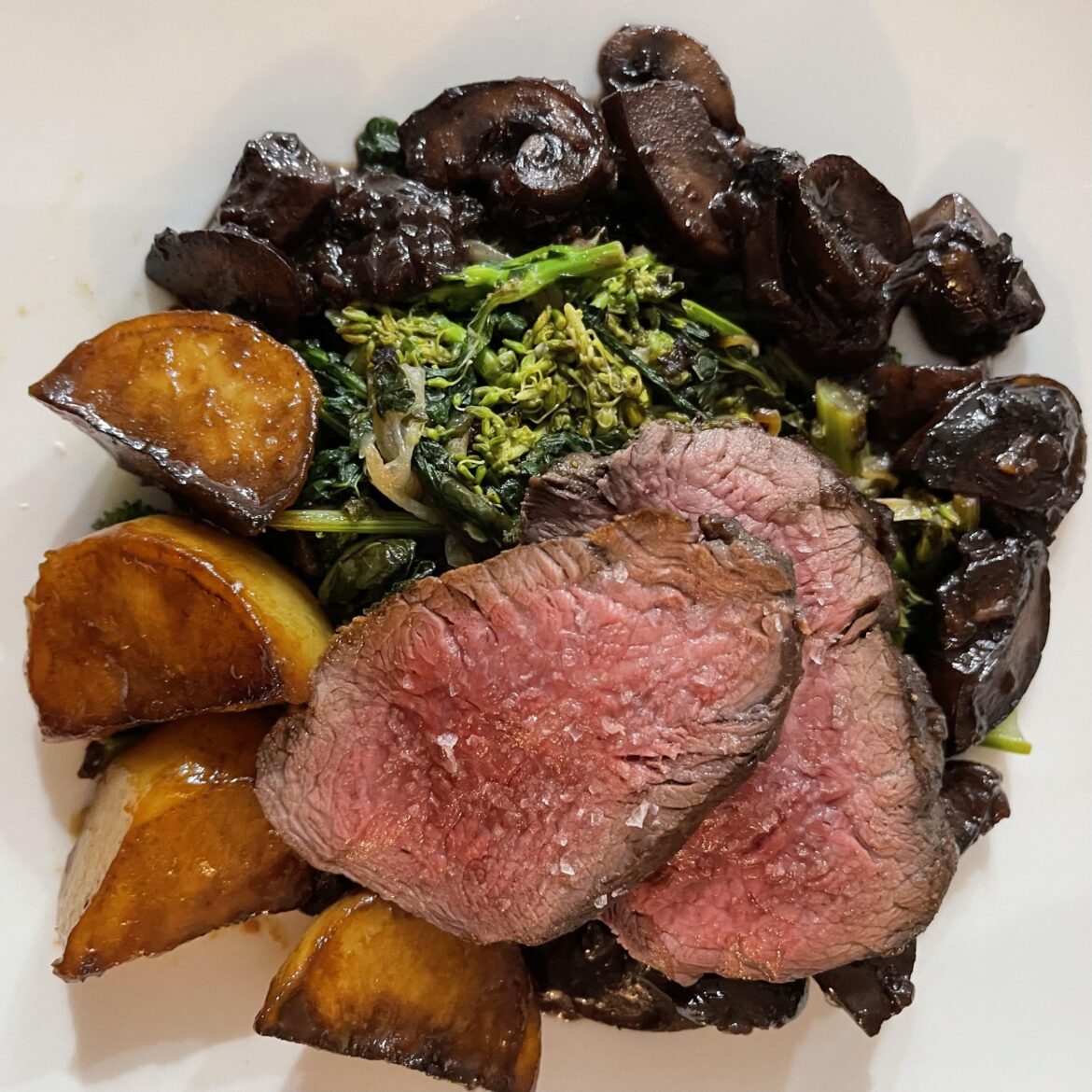 Pan roasted fillet, broccoli rabe, fondant potato, red wine mushrooms.