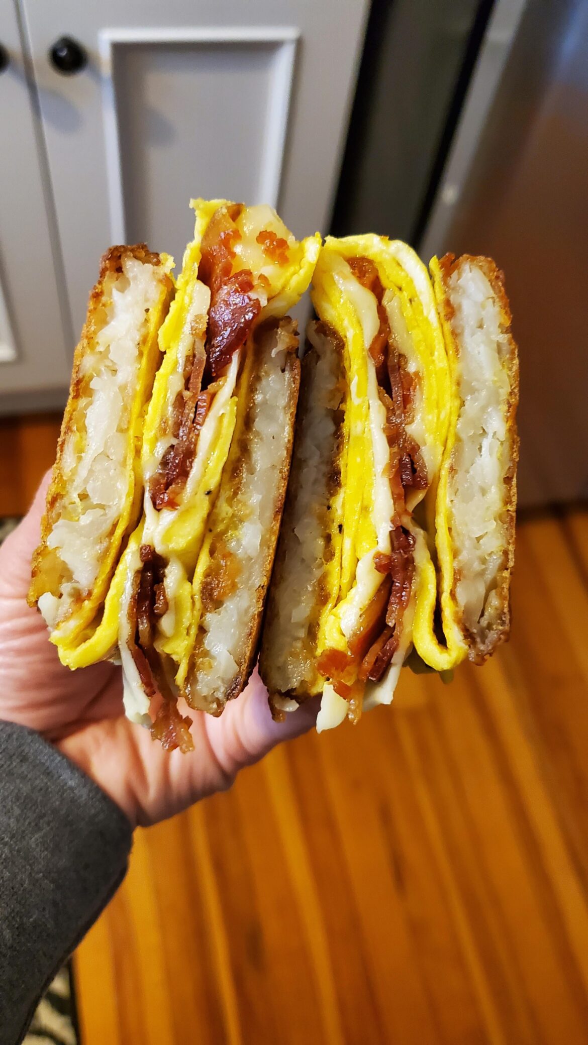 Bacon egg cheese sandwiched between two fried hash brown patties.