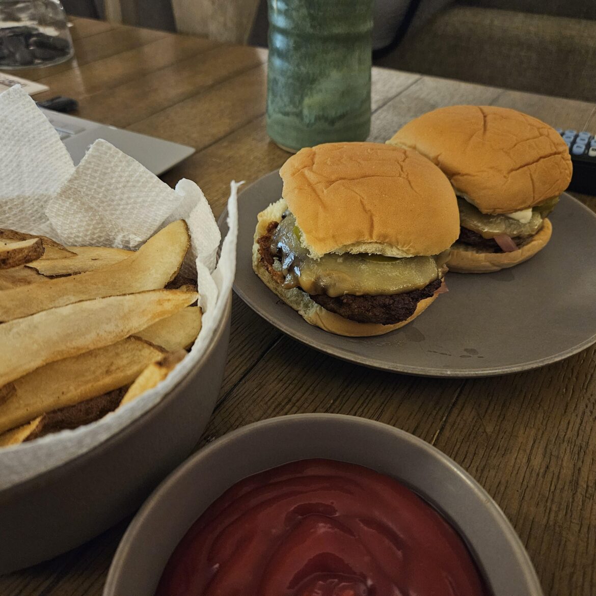 Twin Gouda cheeseburgers on potato rolls, with French Fries and Ketchup.