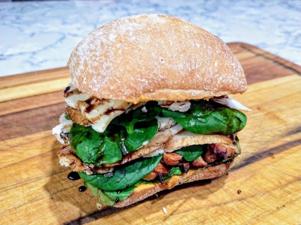Chicken Sandwich - Roasted Chicken, Trader Joe's Triple Cream Brie Cheese with Wild Mushroom, Balsamic Honey Reduction, Spinach, and Red Pepper Hummus on Ciabatta Roll.