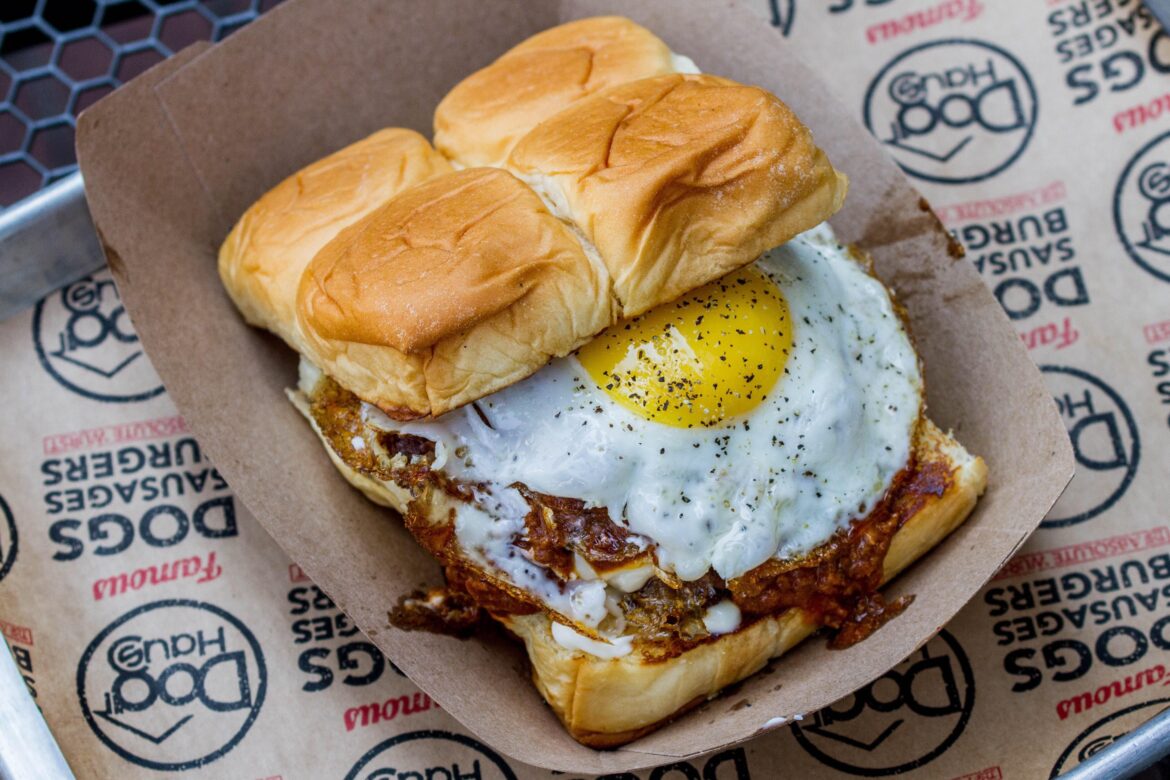 The Hangover Burger - white American cheese, smoked bacon, Haus chili, fried egg, and mayo on a sweet King’s Hawaiian split roll