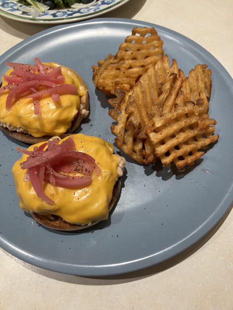 Tuna melt on English muffin with American and pickled onions, and side salad with pistachios, blueberries and Parmesan