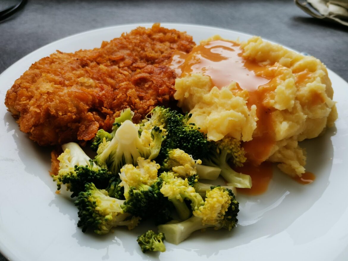 Homemade mashed potatoes with breaded chicken, broccoli and cream sauce.