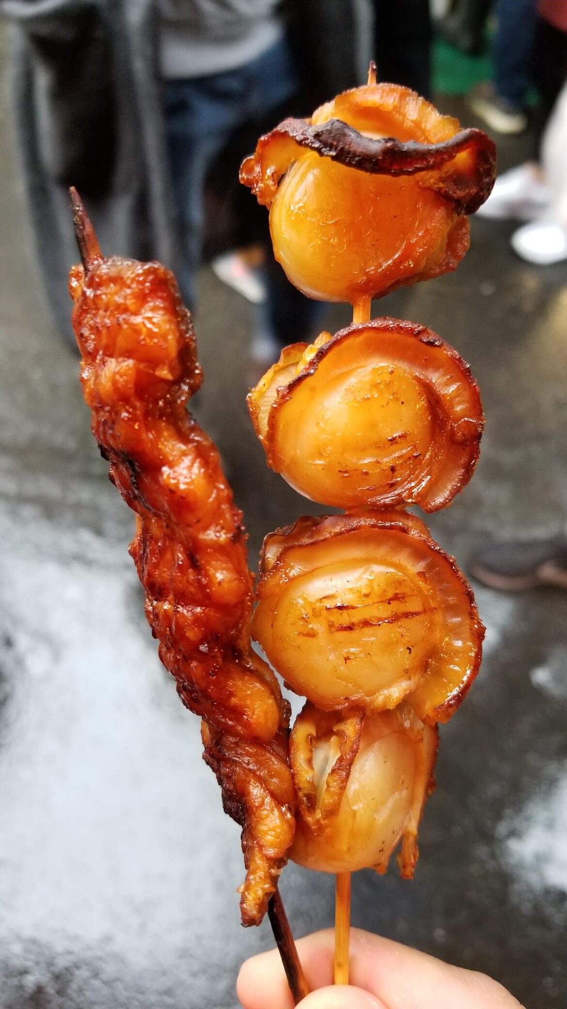 Grilled scallops and eel on skewers in Tsukiji Market , Tokyo.
