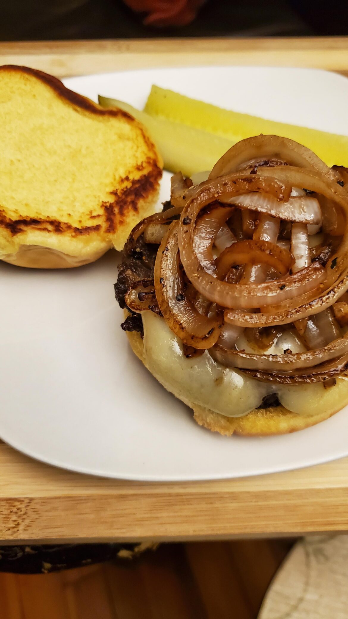 Late night snack. Bulgogi burger topped with grilled onions, melted apple smoked cheddar with mayo on grilled potato bun.