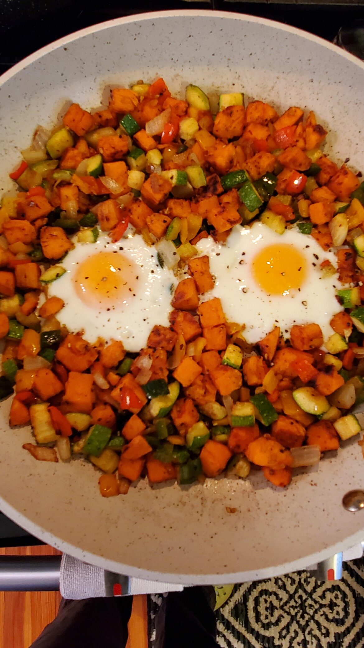 Sweet potato and zucchini hash with fried eggs.