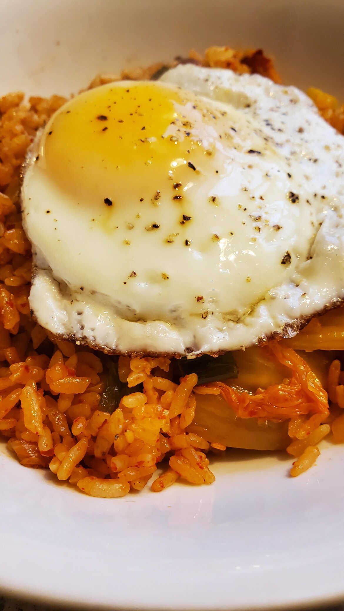 Breakfast this morning is reheated kimchi fried rice with fried egg.
